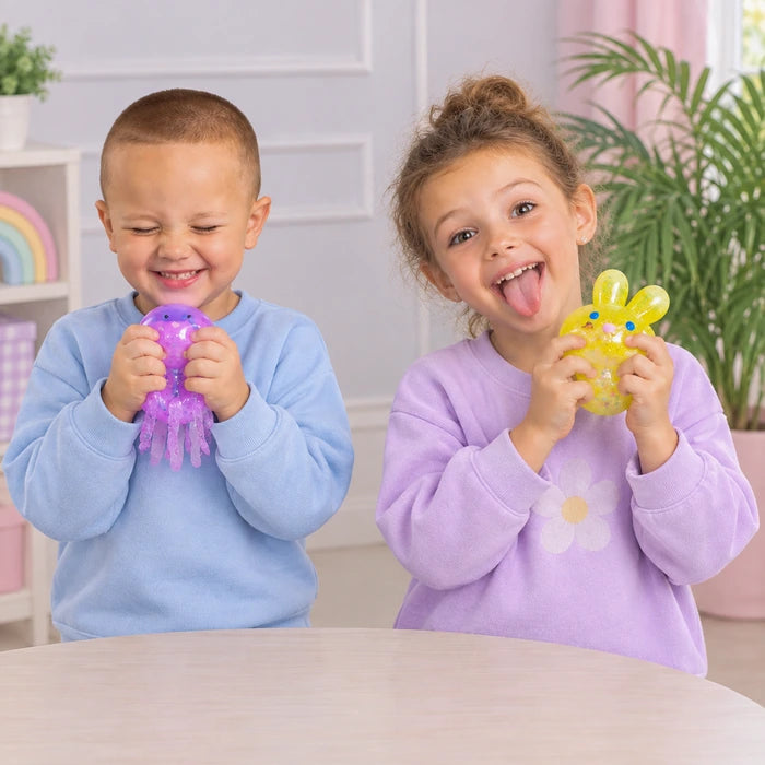 Child squeezing a squishy toy, smiling
